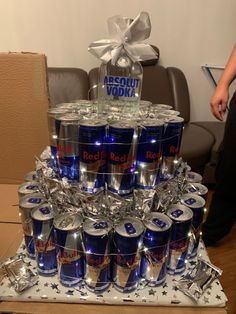 a large stack of cans with lights on them sitting on top of a wooden table