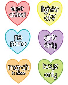 four heart shaped stickers with words on them