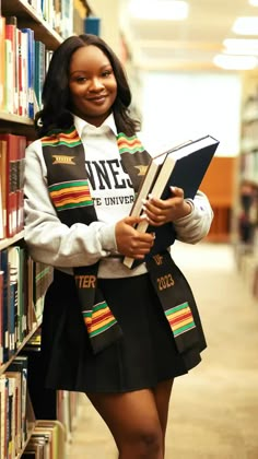 a girl in a school uniform is standing next to a book shelf and smiling at the camera