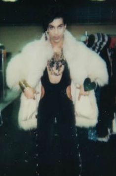 a woman in a fur coat posing for the camera