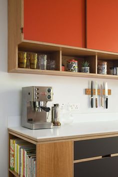 a coffee machine sitting on top of a counter next to a shelf filled with books