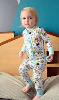 **PRE-ORDER** Products Expected To Ship End of May 2024 Introducing our "Ready To Launch" one-piece bamboo zip-up pajama, the flagship print in our brand new Collection! Designed with comfort, style, and a touch of whimsy in mind, this sleepwear is your child's ticket to a galaxy of sweet dreams. Whether they're soaring through the Milky Way or exploring the rest of the Universe, these pajamas will keep them cozy and stylish while they drift off into dreamland. Let your little one's imagination White Printed Jumpsuits And Rompers For Playwear, Playful Long Sleeve Bodysuit For Bedtime, White Printed Playful Jumpsuits And Rompers, White Long Sleeve Jumpsuits And Rompers With Cartoon Print, White Long Sleeve Jumpsuit With Cartoon Print, Playful Cotton Sleepwear For Bedtime, White Printed Onesie For Bedtime, Printed Long Sleeve Onesie For Bedtime, Playful Long Sleeve Printed Onesie