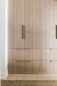 an empty room with wooden cupboards and carpet on the floor in front of it