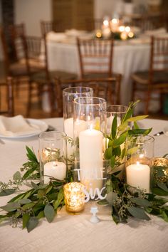 the table is set with candles, flowers and place cards for guests to sit on