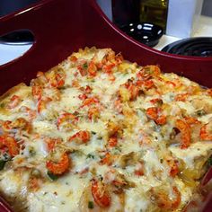 there is a square casserole dish with cheese and vegetables on the top, in a red tray