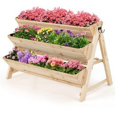 three tiered wooden planter filled with flowers