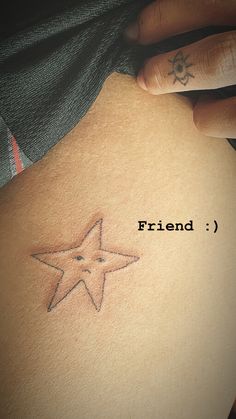 a person with a star tattoo on their back and the word friend written below it