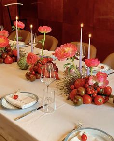 the table is set with flowers and candles