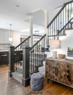 an open floor plan with stairs leading up to the kitchen