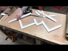 a person cutting up some white paper on a table