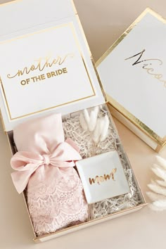 the mother of the bride gift box is filled with pink and gold wedding accessories,