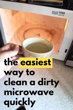 someone is holding a cup in front of an open microwave with the words, the easier way to clean a dirty microwave quickly