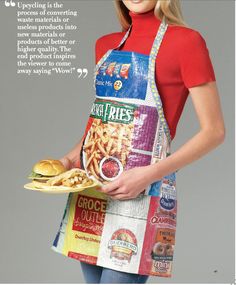 a woman in an apron holding a plate of food