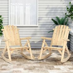 two wooden rocking chairs sitting next to each other on top of a brick floored patio