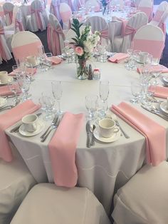 the tables are set with pink and white linens