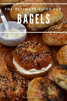 bagels with cream cheese and poppy seeds on them, sitting on a wooden table