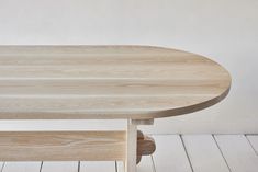 a wooden table sitting on top of a white floor