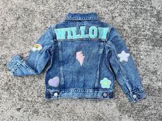 Our custom denim jackets for kids have the name of your choice sewn on the upper back panel of the jacket in chenille letter patches. These personalized jean jackets have additional chenille patches that are sewn on the back, sleeves and front. These name jackets for girls make the perfect customized gift for babies, toddlers and girls! **GAP brand denim jackets in a medium/light wash are used unless specifically stated in the size choice drop down menu. We will substitute with a light wash Old Custom Jean, Jean Jacket Patches, Custom Jean Jacket, Chenille Patches, Gap Brand, Custom Denim Jacket, Jean Jacket For Girls, Letter Patches, Gift For Newborn