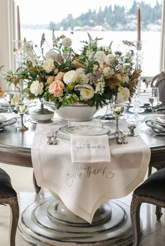 a table with flowers and place settings on it