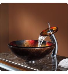 a bowl shaped sink with a faucet running from it's spout