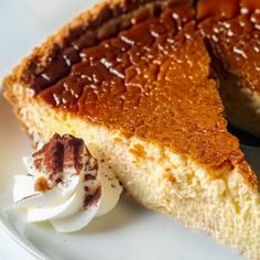 a piece of cake on a plate with whipped cream