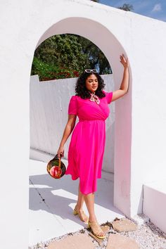 Base color is hot pink. Faux wrap bodice with v neckline. Short fitted sleeve. Ankle length skirt with a removable waist tie. Hidden back zipper. Lined throughout bodice and skirt. Fabric has no stretch. Nursing friendly. Fabric is 100% Polyester. Gentle wash cold; lay flat or hang to dry. Low iron if needed. Available in sizes XXS, XS, S, M, L, XL, 1X, 2X, 3X, 4X, + 5X! summer dress, plus size fashion, summer outfit, matching mom and kid outfit, summer style inspiration, pink dress, midi dress Pink Solid Color Summer Dress, Spring Pink Solid Color Dress, Chic Summer Short Sleeve Dress, Pink Solid Color Maxi Dress For Summer, Pink Solid Color Summer Maxi Dress, Feminine Summer Midi Dress With Surplice Neckline, Pink Knee-length Solid Color Dress, Pink V-neck Maxi Dress Solid Color, Pink Knee-length Dress