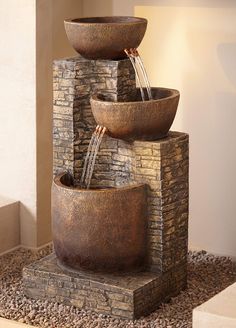 a fountain with three bowls on top of it