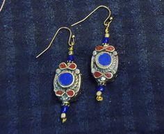 Nepali silver and gold wash beads inlaid with Lapis  and carnelian. Length is 38mm Bohemian Gold Carnelian Earrings, Gold Bohemian Carnelian Earrings, Metal Jewelry With Large Beads As Gift, Metal Jewelry With Large Beads For Gift, Antique Amber Jewelry With Polished Beads, Spiritual Brass Jewelry For Festive Occasions, Traditional Gold Beaded Earrings, Traditional Earrings With Gold Beads, Red Oval Jewelry For Ceremonial Occasion