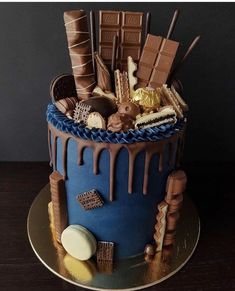 a blue cake with chocolate icing and candies on it