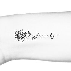 a black and white photo of a wrist tattoo with the word family written on it