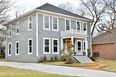 a gray house with white trim and windows