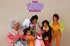 a group of people standing next to each other in front of a sign that says the proud family