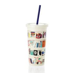 a plastic cup with a blue straw in it and pictures on the side, sitting on a white surface