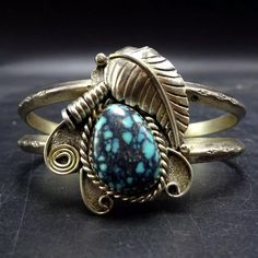 TURQUOISE STERLING SILVER CUFF BRACELET DESCRIPTION:  Featuring a breathtaking specimen of blue turquoise with tight black spiderweb matrix, this bracelet will be a cherished addition to your collection of fine vintage Southwestern and Native American jewelry. MEASUREMENTS: Interior of the cuff measures 5 1/8" with an additional 1" slightly adjustable gap. Total circumference: 6 1/8" Measures 2 1/8" straight across the widest part  (from wrist bone to wrist bone) Bracelet face measures 1 3/8" wi Bone Bracelet, Jewelry Measurements, Bones Bracelet, Cowgirl Jewelry, Sterling Silver Cuff Bracelet, Sterling Silver Cuff, Silver Cuff Bracelet, American Jewelry, Native American Jewelry