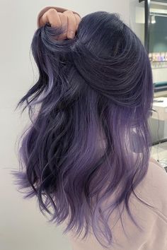 This hairstyle has a silver bottom that smoothly changes into shades of purple, making it look like a twilight sky. The hair is cut into soft sections, adding fullness and flow, which makes the colors interact with a vibrant, nearly shimmering effect. The loose waves flow gently, emphasizing the seamless mix of silvery colors and - Click to see more of Discover the Mesmerizing Silver Purple Hair Trends of 2024 and follow us for more hairstyle ideas. // Photo Credit: Instagram @hairbyseany Silver Purple Hair, Purple Grey Hair, Hairstyles Male, Braids Natural, Purple Hair Highlights, Hair Color Underneath, Dyed Hair Inspiration, Lavender Hair