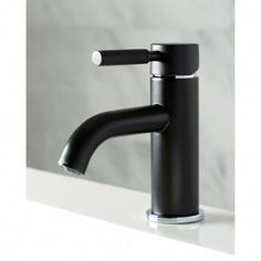 a black faucet sitting on top of a white counter