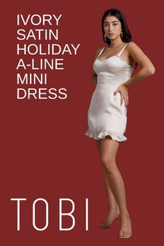 Show off your feminine side in this sexy ivory satin holiday a-line mini dress. Did you know you can get dress up cocktail party gowns for Christmas and New Year's Eve outfits on sale? Now's your chance! Why pay more when you can get dazzling winter festivity clothing and formal attire for ladies at affordable prices from TOBI. #shoptobi #holidaydresses #minidresses #satindresses New Years Eve Outfits, Silky Dress