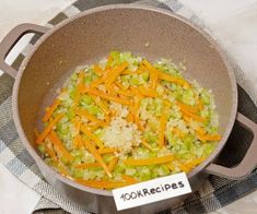 a pan filled with vegetables on top of a table