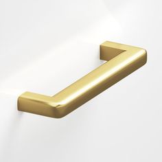 a gold door handle on a white wall