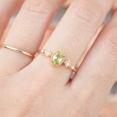 * ≈6x4mm oval peridot * Band width: ≈1.3mm * G color SI diamonds, ≈0.04ctw * Setting style: Prong setting, low profile (sits flush on your finger) * Material: Solid 14k yellow gold, rose gold or white gold * Made of 100% recycled precious metal and ethically sourced gemstone * Comes in a gift box with a bow ready for gifting * Handmade with love and great care in New York * Please note that colors may vary slightly as they are genuine gemstones. Our Dedication All our jewelry is designed and cre Oval Green Rose Cut Diamond Rings, Oval Peridot Diamond Ring, Oval Peridot Solitaire Jewelry, Oval Peridot Rings Fine Jewelry, Oval Peridot Ring In Yellow Gold, Oval Peridot Birthstone Ring For May, Oval Yellow Gold Peridot Rings, Green Peridot Birthstone Ring, Dainty Style, Oval Lime Green Ring For Gift