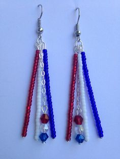 red, white and blue beaded earrings hanging from silver hooks