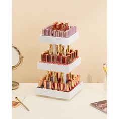 three tiered display with lipsticks on it