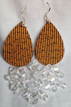 Lovely pair of statement earrings to wear for any occasion, with an orange vertical bamboo pattern The pattern is on both sides. L: 5cm, W 3.5cm, dangle 7cm Ear wires sterling silver,  all other metal is silver plated.  Wooden shape covered with upcycled cotton fabric. Handmade Orange Teardrop Earrings, Bamboo Pattern, Wooden Shapes, Teardrop Earrings, Ear Wires, Statement Earrings, Hippie Boho, Jewelry Earrings Dangle, Etsy Earrings