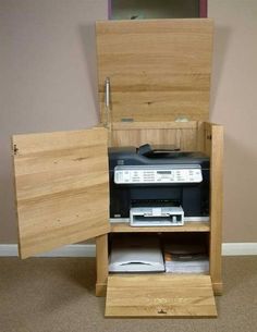 an open wooden cabinet sitting on top of a carpeted floor next to a wall