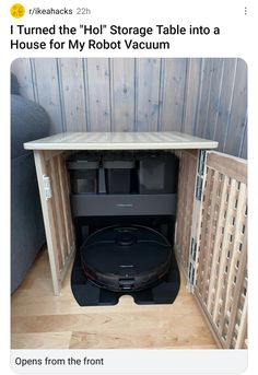 a room with a table in the middle and trash cans on the floor below it that says, i turned the'ho'storage table into a house for my robot vacuum