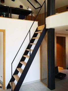 a black and white stair case next to a wall