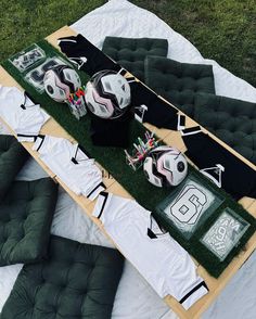 a table with soccer balls and shirts on it