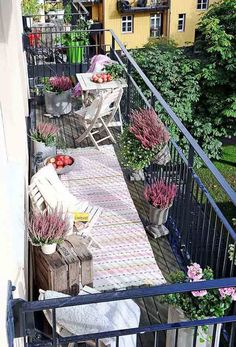 the balcony is decorated with flowers and potted plants