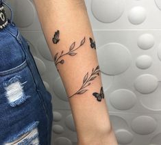 a woman's arm with butterflies on it