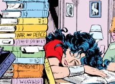 a woman laying on top of a pile of books next to a stack of books